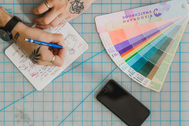 Creative workspace with colour swatches and design materials